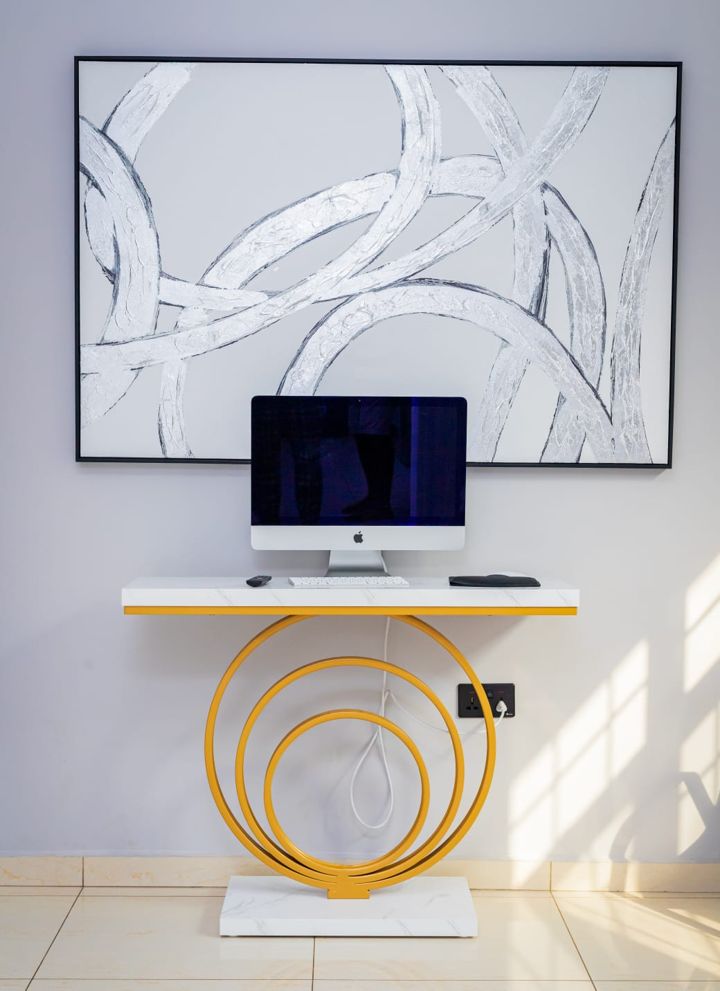 Desk with an iMac beneath a large abstract painting